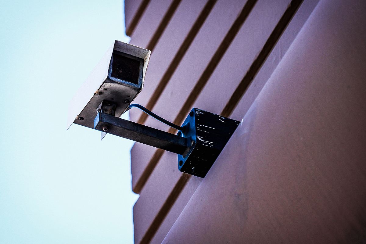 gray surveillance camera on gray wall